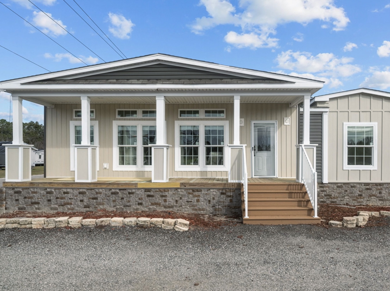 Front view of a modern manufactured home in Florida featuring a raised foundation and high-quality construction
