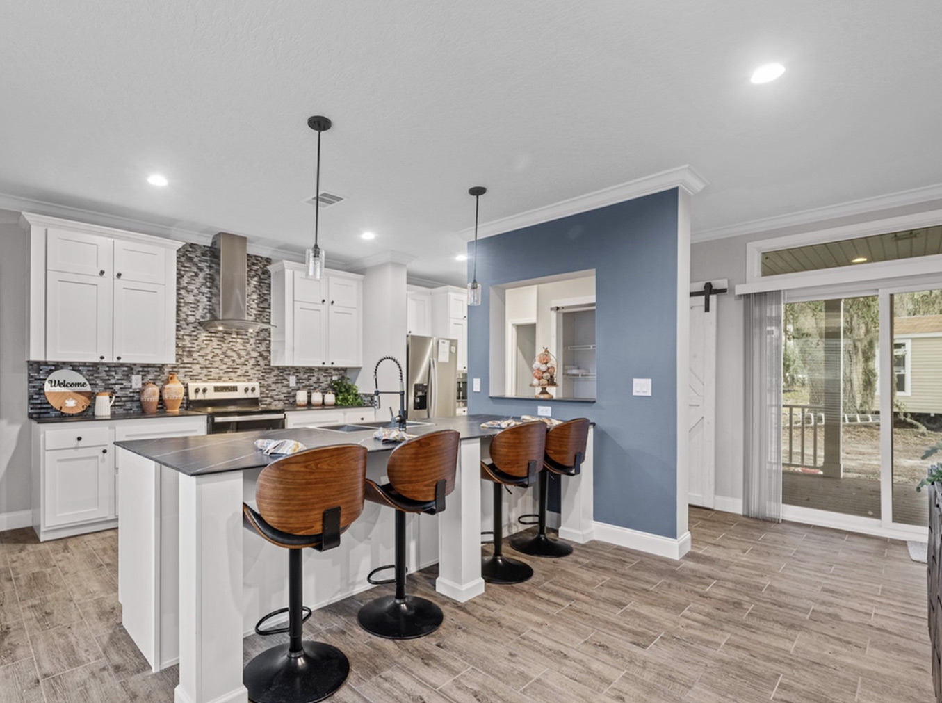 Modern kitchen in a custom-built manufactured home, featuring quality finishes and a spacious island for dining